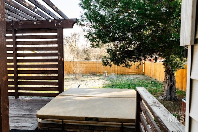 wooden deck with a fenced backyard and a pergola