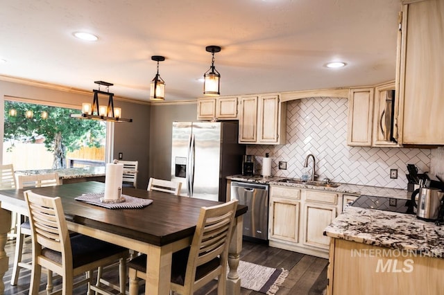 kitchen featuring a sink, light brown cabinetry, ornamental molding, stainless steel appliances, and dark wood-style flooring