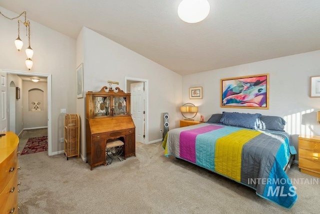 carpeted bedroom featuring vaulted ceiling