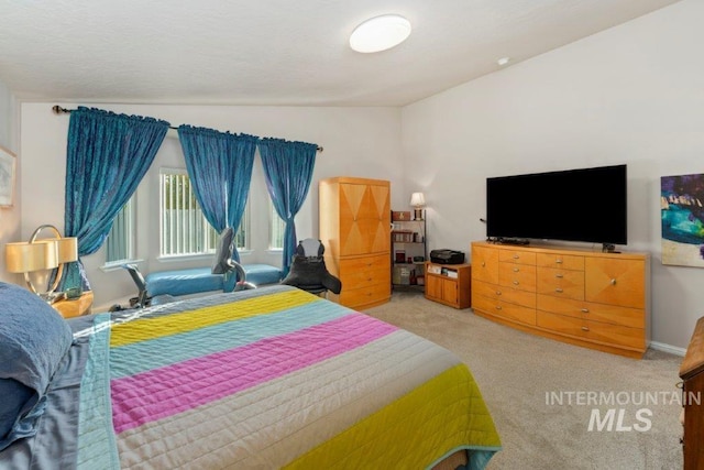 carpeted bedroom featuring lofted ceiling