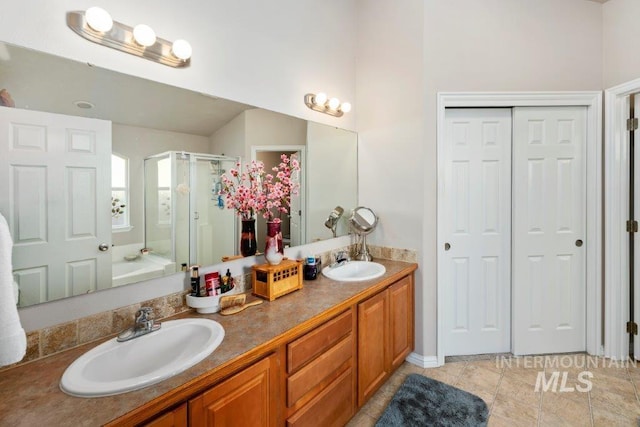 bathroom with a shower with door and vanity