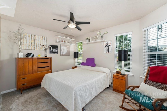 bedroom featuring light carpet and ceiling fan