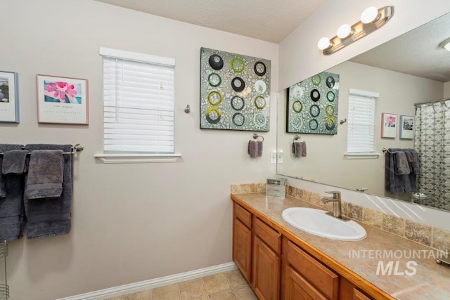 bathroom featuring vanity, tile patterned flooring, and a wealth of natural light