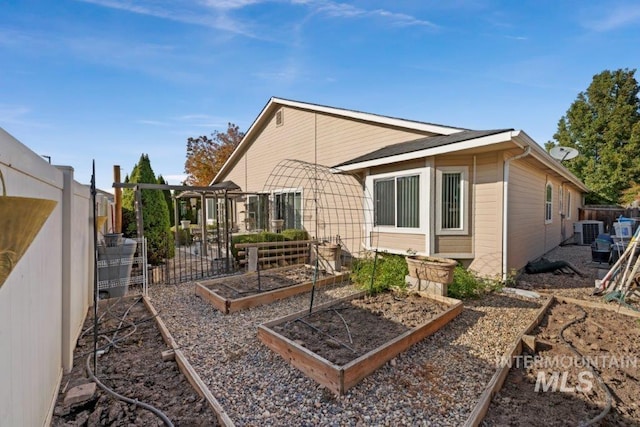 rear view of house featuring central AC