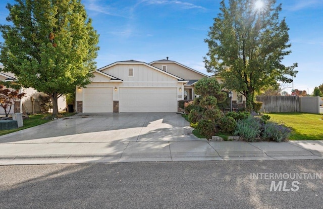 view of front of property with a garage, a front lawn, and central AC unit