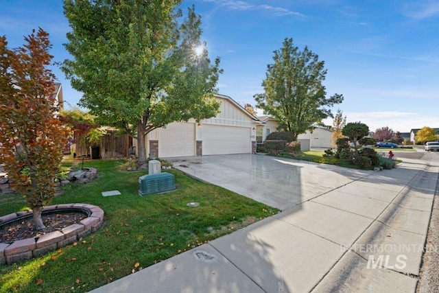 view of front of home with a front yard and a garage