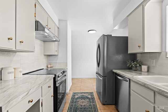 kitchen featuring appliances with stainless steel finishes, light tile patterned floors, and backsplash