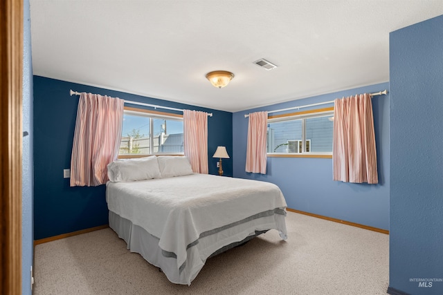 bedroom featuring light colored carpet