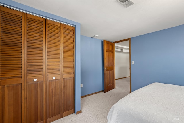 bedroom with light carpet and a closet