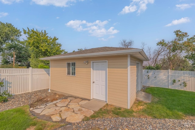 view of outbuilding with a yard