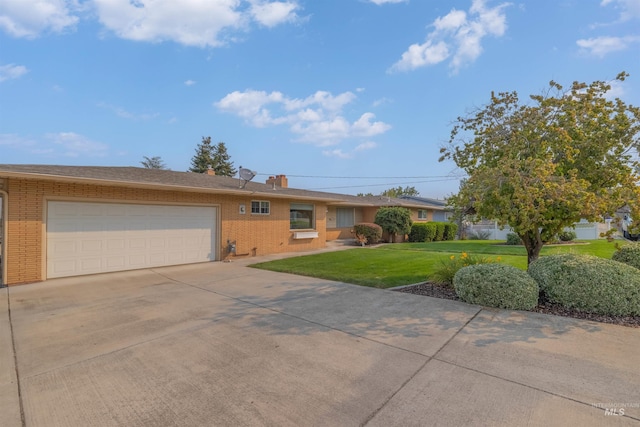 single story home featuring a garage and a front yard