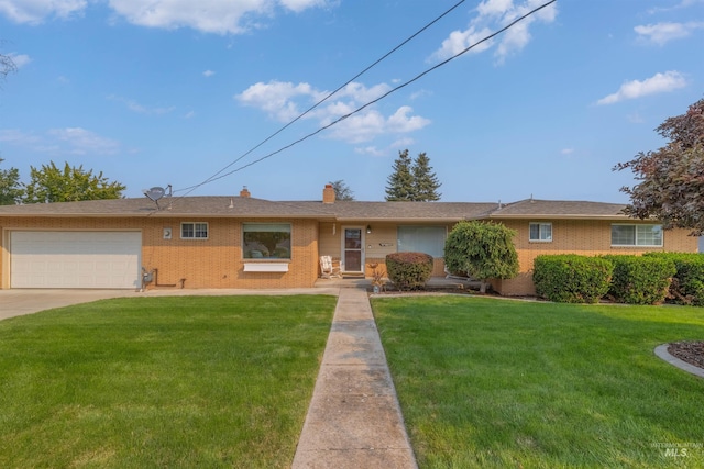 single story home featuring a garage and a front yard