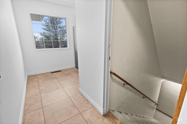 hall featuring light tile patterned flooring