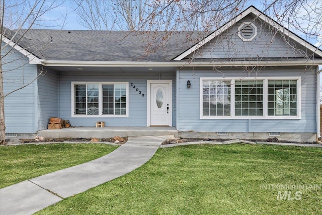 view of front of home with crawl space, covered porch, roof with shingles, and a front yard