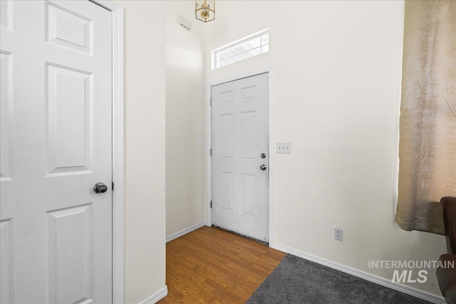 entrance foyer featuring baseboards and wood finished floors