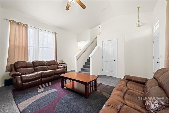 living room with baseboards, stairway, lofted ceiling, carpet flooring, and a ceiling fan