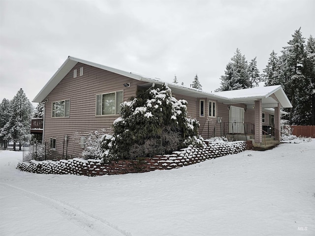 view of snowy exterior featuring a porch