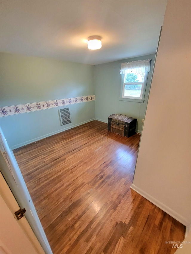 unfurnished room featuring hardwood / wood-style floors