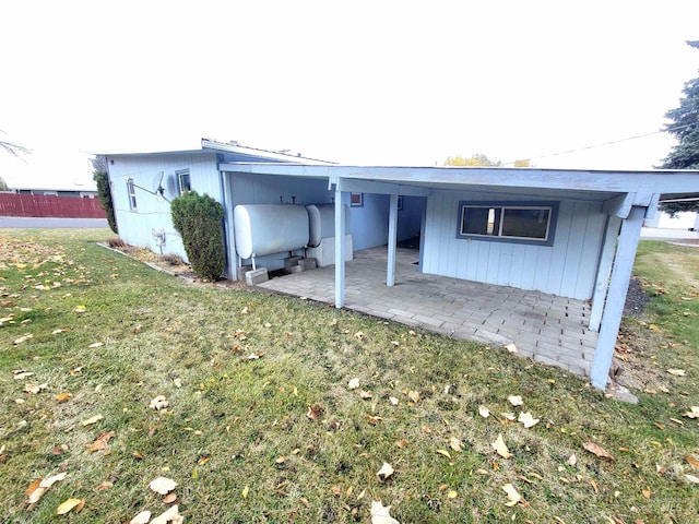 rear view of house featuring a yard