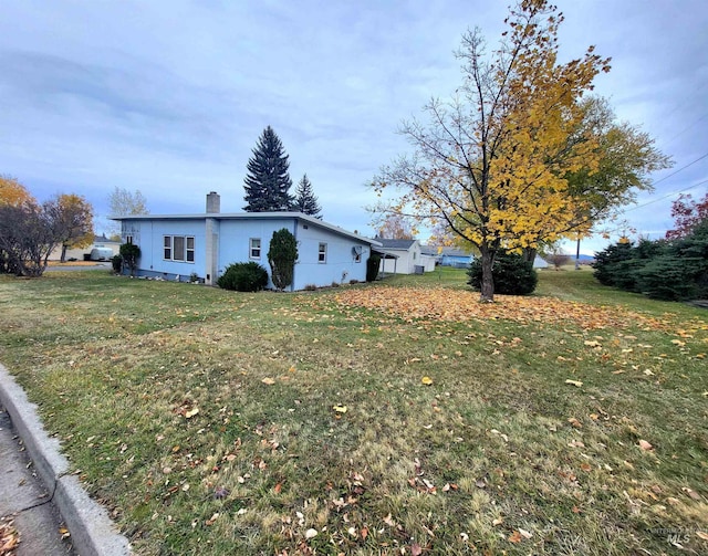 view of side of home with a lawn