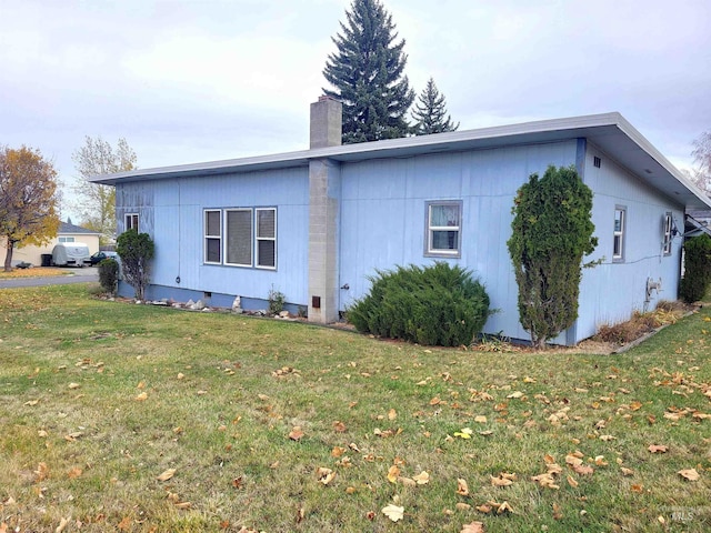 rear view of property with a lawn