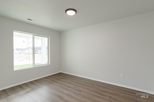 unfurnished room featuring hardwood / wood-style flooring