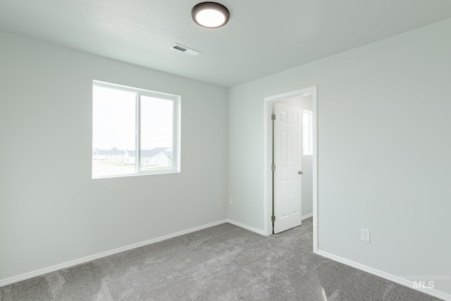 unfurnished room featuring light colored carpet