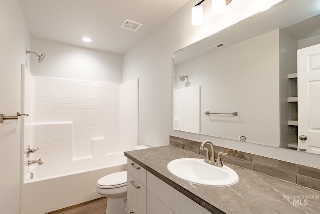 full bathroom with vanity, toilet, shower / washtub combination, and hardwood / wood-style flooring