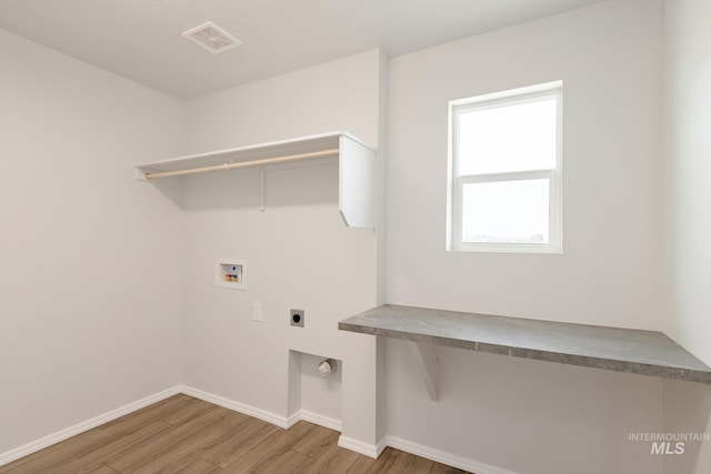 laundry room with hookup for a washing machine, hardwood / wood-style floors, and hookup for an electric dryer