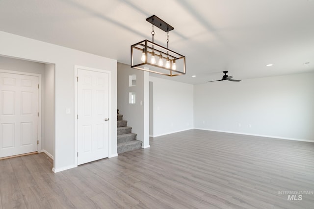 interior space with ceiling fan and light hardwood / wood-style flooring