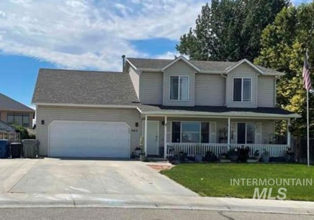 3413 Cedar Park Ct, Nampa, ID 83686 - view of front of home featuring a porch, driveway, a front yard, and an attached garage