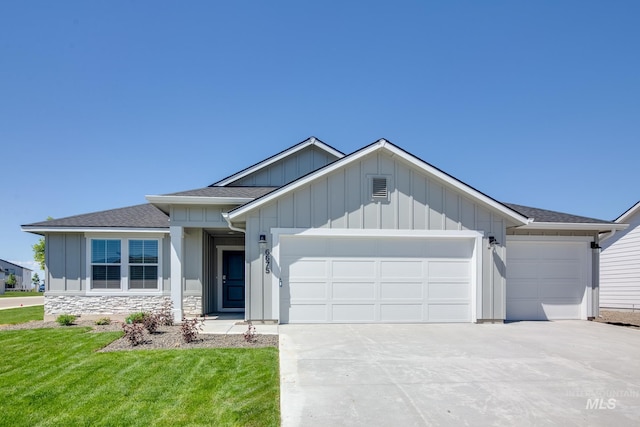 view of front of home featuring a garage and a front lawn