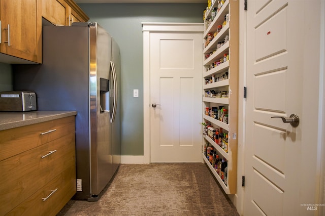 kitchen with dark colored carpet and stainless steel fridge