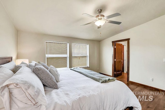 bedroom with baseboards, dark wood finished floors, ceiling fan, and lofted ceiling
