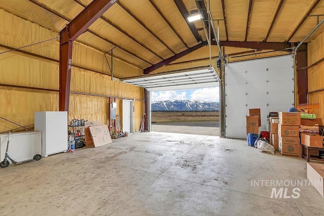 garage with electric panel and a mountain view