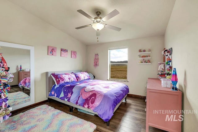 bedroom with a ceiling fan, baseboards, and wood finished floors
