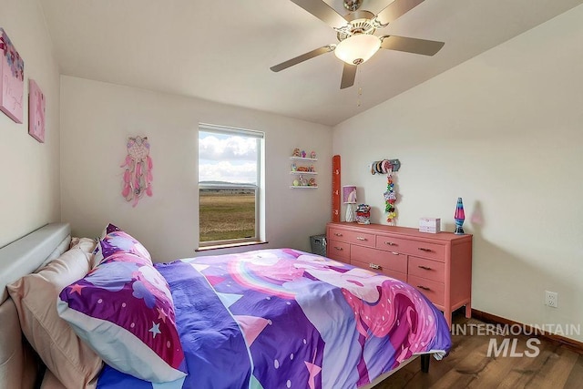 bedroom featuring a ceiling fan, lofted ceiling, and wood finished floors