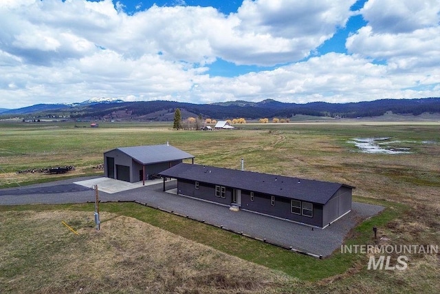 birds eye view of property featuring a mountain view and a rural view