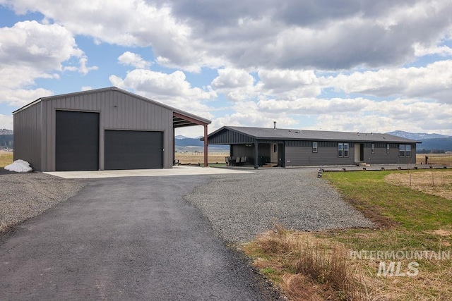 view of front of house featuring an outdoor structure and a detached garage