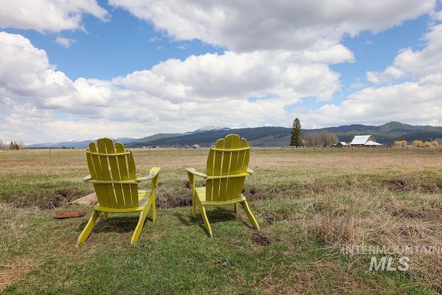 view of yard with a mountain view and a rural view