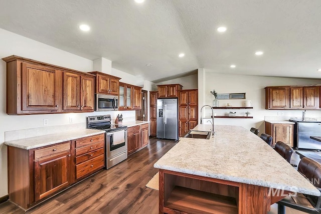 kitchen with open shelves, a sink, a breakfast bar area, stainless steel appliances, and lofted ceiling