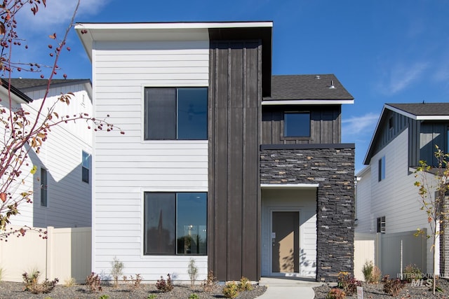 4403 N Magical Creek Ave, Meridian, ID 83646 - back of house with fence, stone siding, and board and batten siding