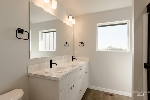 4403 N Magical Creek Ave, Meridian, ID 83646 - full bathroom with double vanity, visible vents, toilet, and a sink