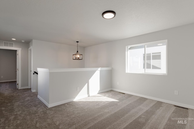 4403 N Magical Creek Ave, Meridian, ID 83646 - spare room with baseboards, a chandelier, visible vents, and carpet