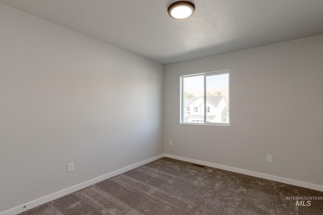 4403 N Magical Creek Ave, Meridian, ID 83646 - empty room with dark colored carpet, visible vents, and baseboards