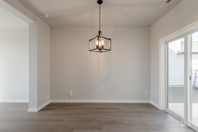 4403 N Magical Creek Ave, Meridian, ID 83646 - unfurnished dining area with visible vents, baseboards, wood finished floors, and a notable chandelier