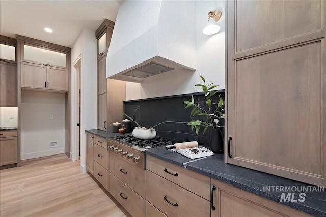 9989 W Bouvardia St, Star, ID 83669 - kitchen featuring premium range hood, stainless steel gas stovetop, light wood-type flooring, glass insert cabinets, and recessed lighting