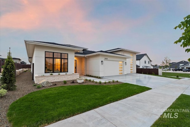 9989 W Bouvardia St, Star, ID 83669 - view of front facade with concrete driveway, an attached garage, and stucco siding