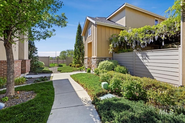 3631 S Pheasant Tail Way, Boise, ID 83716 - view of home's exterior with board and batten siding, fence, and stone siding