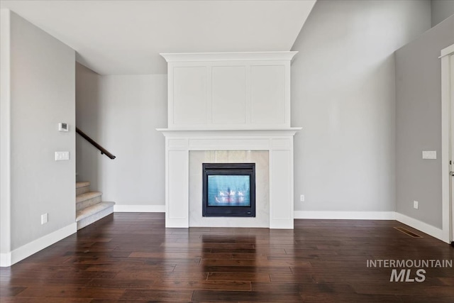 3631 S Pheasant Tail Way, Boise, ID 83716 - unfurnished living room with a fireplace, dark wood-type flooring, baseboards, and stairs